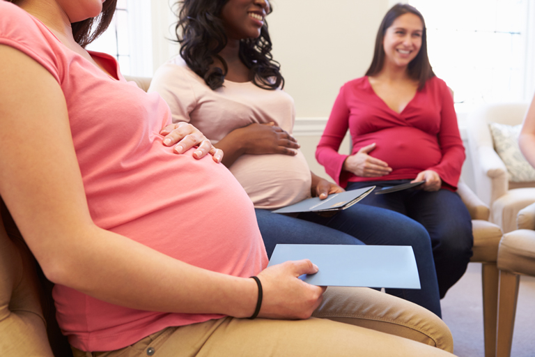 three pregnant women sitting in chairs