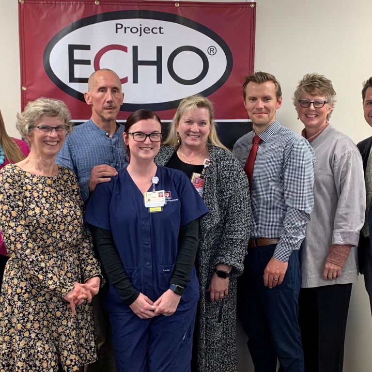 group of people standing in front of project echo sign