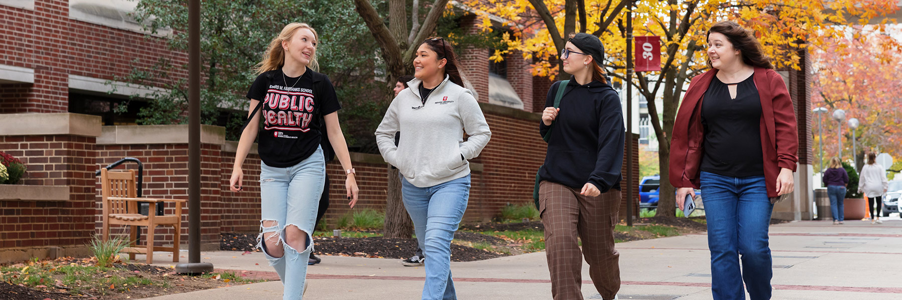 four students walking on campus